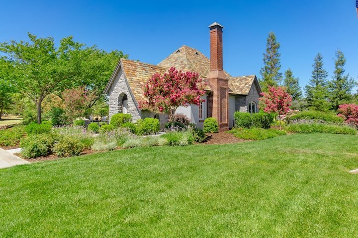 The Fairytale Retreat from the lawn, with its brick chimney and crepe myrtles